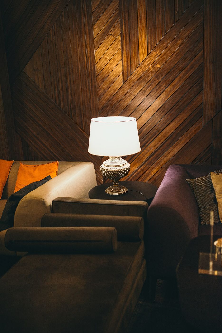 Table lamp glowing beside sofas in a cozy room